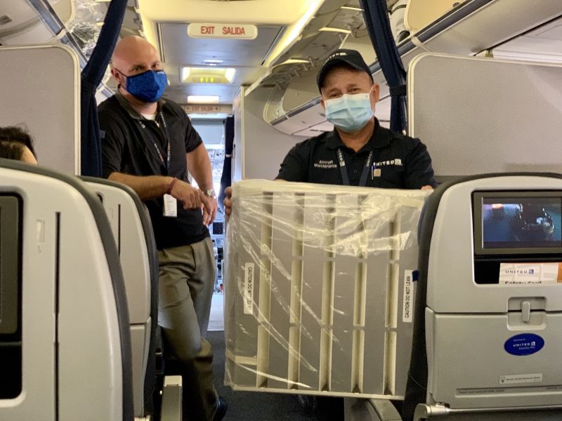A United team member holds a HEPA filter that instills clean air throughout the airplane cabin.
